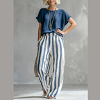 A woman wearing Arenzza casual solid top and striped wide-leg pants, stylish weekend outfit, smiling outdoors.