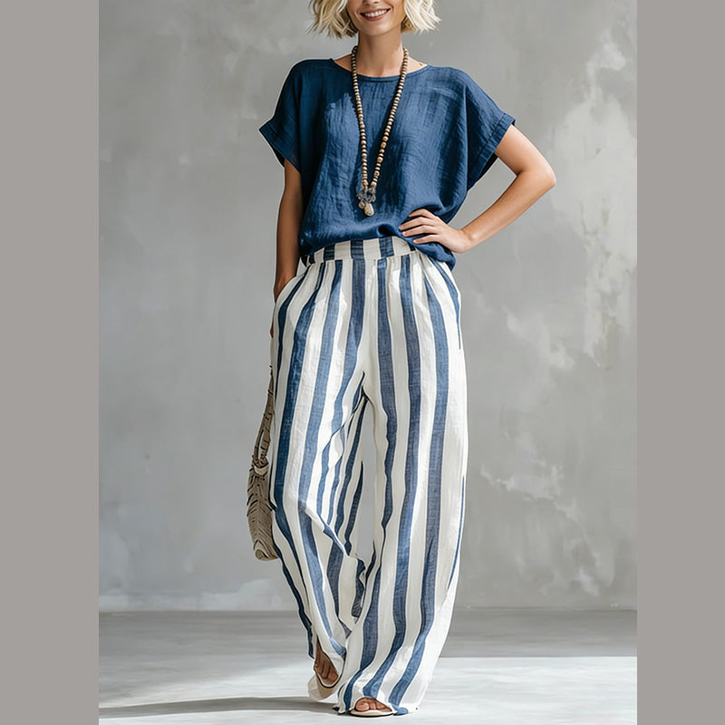 A woman wearing Arenzza casual solid top and striped wide-leg pants, stylish weekend outfit, smiling outdoors.