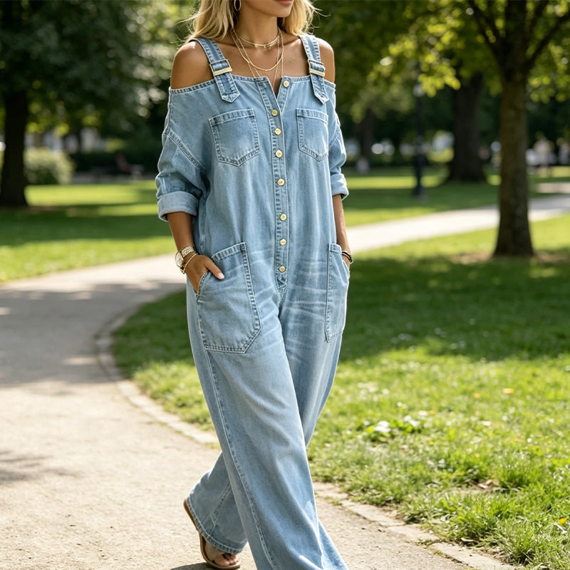 A woman wearing a beige loose fit wide-leg overall jumpsuit with pockets, stylish and comfortable, by Arenzza.