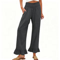 A woman wearing Arenzza boho style ruffle trim lounge pants, featuring a relaxed fit and ruffled details at the hem.