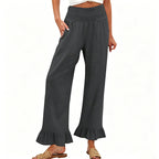 A woman wearing Arenzza boho style ruffle trim lounge pants, featuring a relaxed fit and ruffled details at the hem.