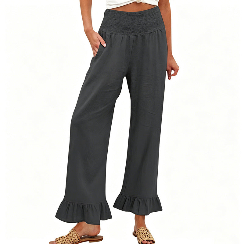 A woman wearing Arenzza boho style ruffle trim lounge pants, featuring a relaxed fit and ruffled details at the hem.