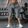 Men's Arenzza quick-dry athletic capri pants in black, showing the lightweight, fitted design with elastic waistband and side pockets.