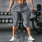 Men's Arenzza quick-dry athletic capri pants in black, showing the lightweight, fitted design with elastic waistband and side pockets.