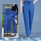A pair of high waist ultra-stretch mom jeans from Arenzza, shown in a natural pose, highlighting the fit and denim fabric.