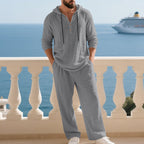 A Men’s Arenzza hooded casual loose top and pants 2-piece set, displayed on a mannequin, in a relaxed fit and comfortable style.