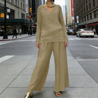 A woman wearing a women's V-neck lounge set with wide-leg pants by Arenzza, featuring a relaxed fit in soft fabric.