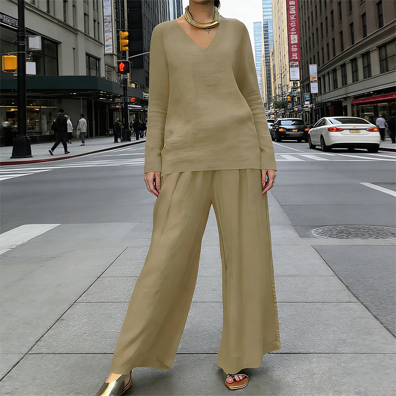 A woman wearing a women's V-neck lounge set with wide-leg pants by Arenzza, featuring a relaxed fit in soft fabric.