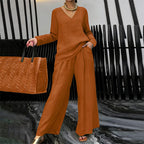 Women's V-neck lounge set with wide-leg pants by Arenzza, soft fabric, comfortable fit, shown in a relaxed indoor setting.