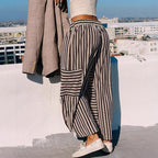 A woman wears Arenzza women's striped wide-leg drawstring pants, showcasing the relaxed fit and stylish striped pattern.