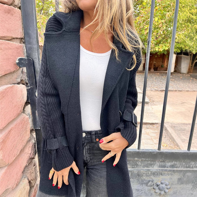 A women’s mid-length lapel double-breasted coat by Arenzza in a classic design, shown hanging on a neutral background.