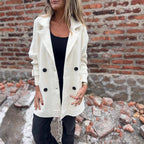 Women’s mid-length double-breasted coat with lapel collar by Arenzza, shown in a stylish, neutral-colored fabric.