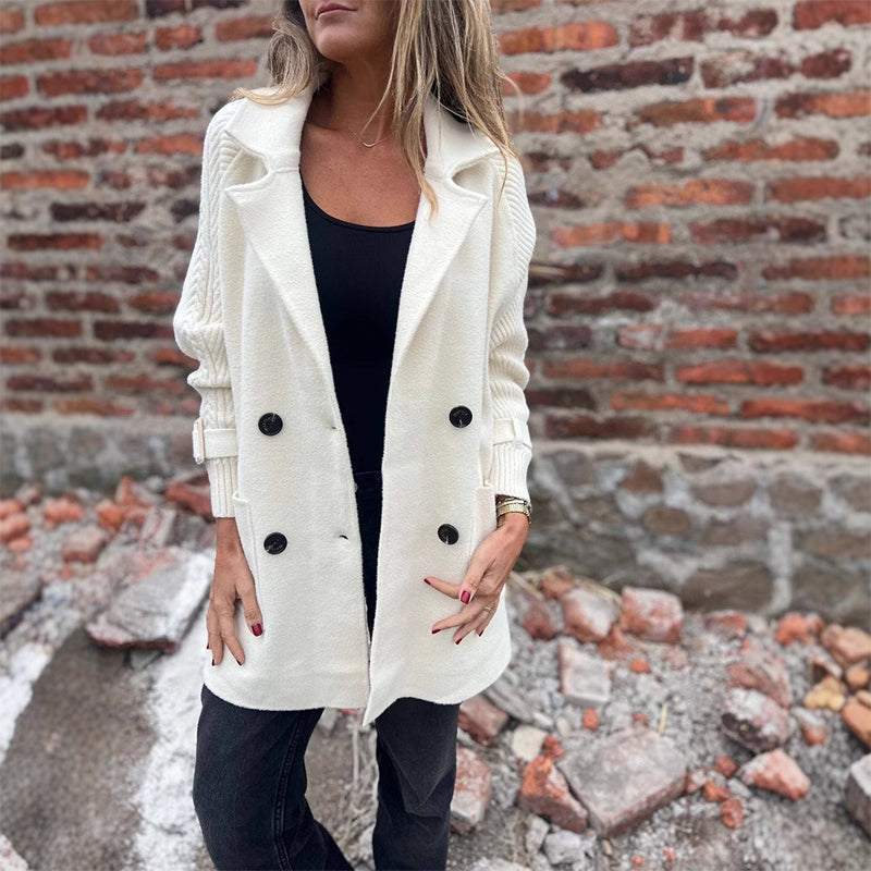 Women’s mid-length double-breasted coat with lapel collar by Arenzza, shown in a stylish, neutral-colored fabric.