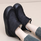 A pair of warm waterproof snow boots by Arenzza with thick soles, shown in black with padded insulation for winter protection.