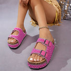 A pair of Arenzza cork slide sandals with double buckles, sparkling accents, designed for summer and beach wear.