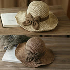 A stylish woven straw sun hat with a bow from Arenzza, perfect for summer outdoor wear.