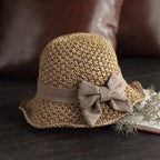 Aarenza woven straw sun hat with a bow, stylish and elegant for summer, featuring a wide brim and natural straw texture.