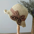 Arenzza woven straw sun hat with bow, stylish and elegant accessory for sunny weather, featuring a wide brim and decorative ribbon.