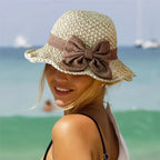 A woven straw sun hat with a bow, stylish and elegant, by Arenzza, perfect for summer accessories and sun protection.