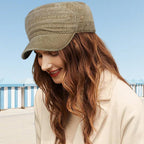Aarenza flat-top duckbill cap in distressed style, breathable and fashionable, shown in a close-up view with a flat brim and textured fabric.