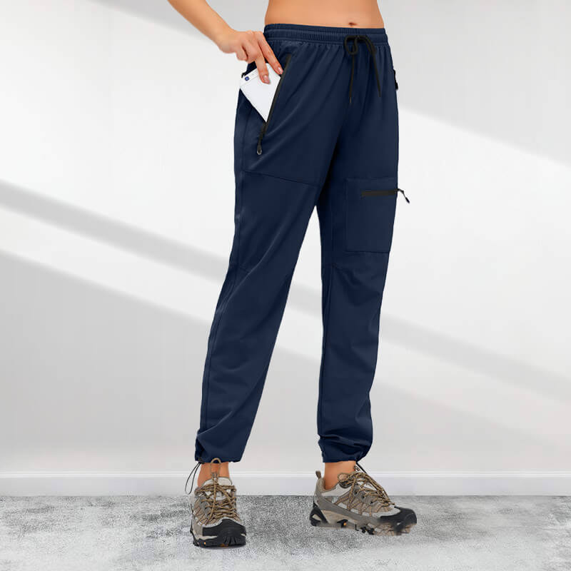 A pair of women's Arenzza hiking pants with five zipper pockets, quick-drying fabric, designed for outdoor adventure.