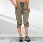 A woman wearing Arenzza women's hiking pants with five zipper pockets, quick-drying outdoor clothing suitable for hiking and outdoor activities.