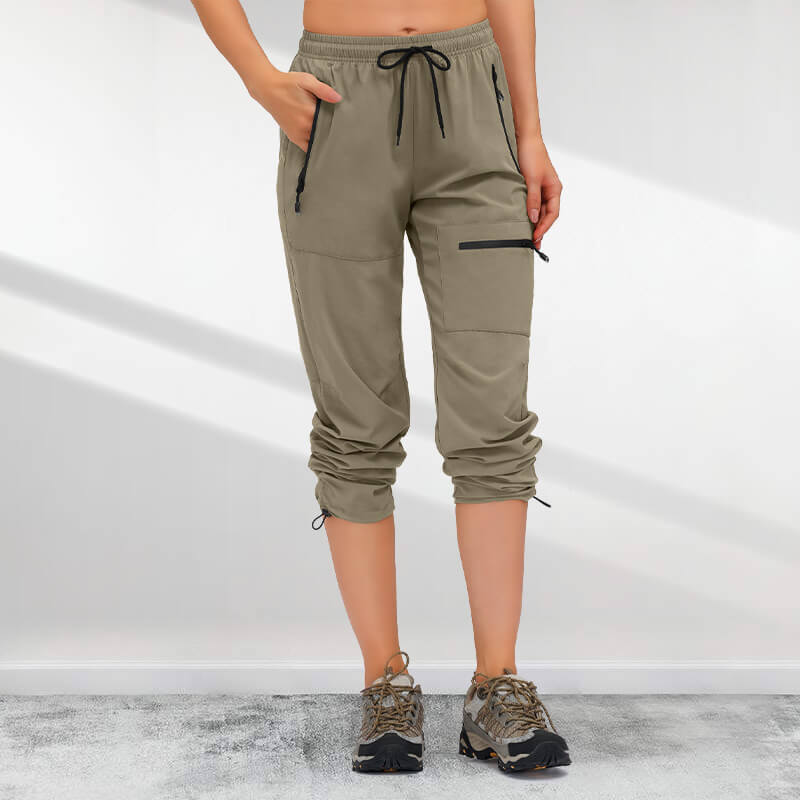 A woman wearing Arenzza women's hiking pants with five zipper pockets, quick-drying outdoor clothing suitable for hiking and outdoor activities.