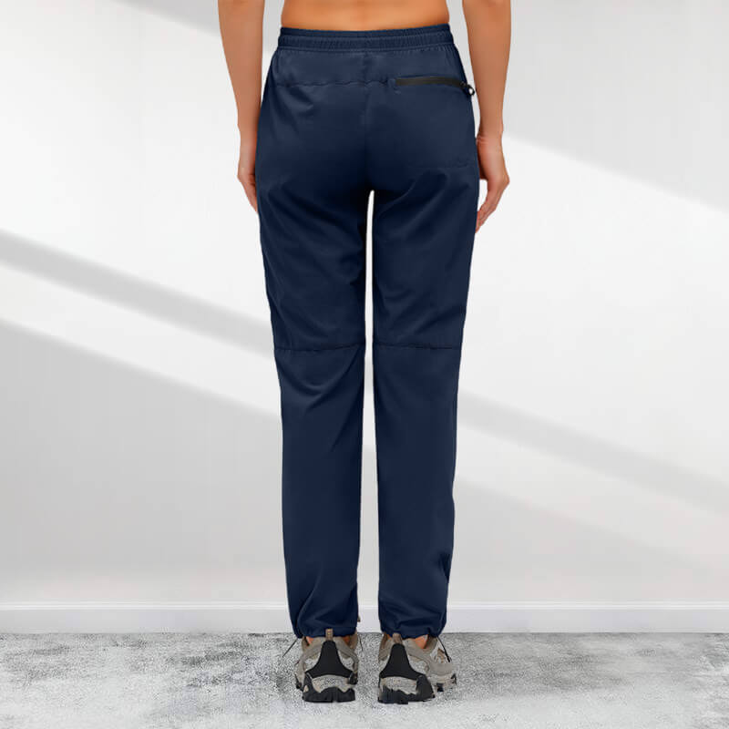 A pair of women's Arenzza hiking pants with five zipper pockets, quick-drying fabric, designed for outdoor adventure and comfort.