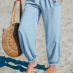 A woman wearing Arenzza women's smocked high waist harem pants in light fabric, perfect for effortless summer comfort.