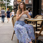 Women's printed wide-leg drawstring trousers by Arenzza, featuring a floral pattern and relaxed fit, laid flat on a white background.