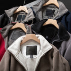 A unisex Arenzza double-layer hooded jacket in neutral color, displayed on a hanger, showcasing its stylish design and layered fabric.