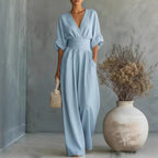 Aarenza women's V-neck high waist wide-leg jumpsuit in black, displayed on a hanger with a clean background.