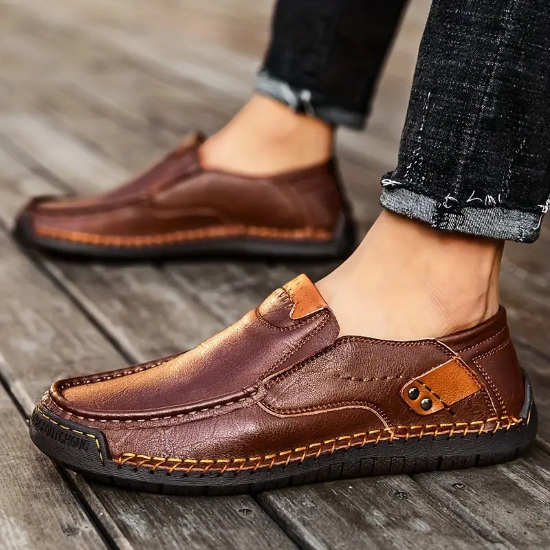A pair of breathable calfskin leather men's shoes by Arenzza, showcasing classic and comfortable design in natural outdoor setting.
