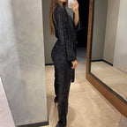 Aarenza women's sparkly V-neck belted jumpsuit in black, featuring shimmering fabric and stylish design for elegant wear.