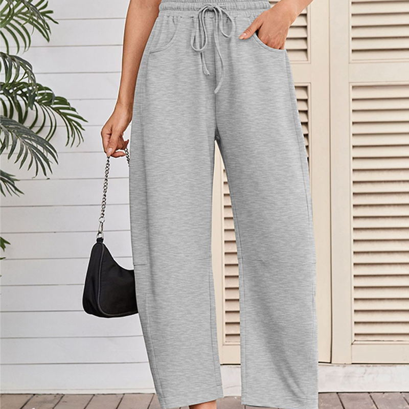 A pair of Arenzza Drawstring Pocket Capri Sweatpants in black with side pockets and elastic waistband, displayed on a plain background.