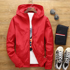 A lightweight outdoor hooded jacket from Arenzza, shown in a natural outdoor setting with a zip-up front and adjustable hood.