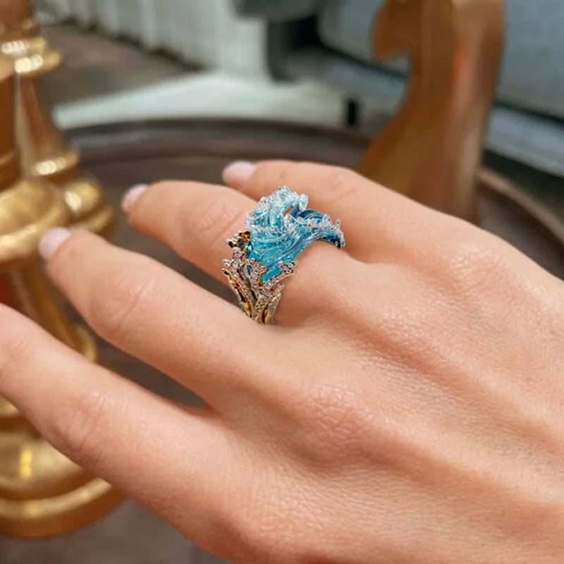 Elegant blue necklace, ring, and earrings set by Arenzza featuring coordinated jewelry with intricate details.