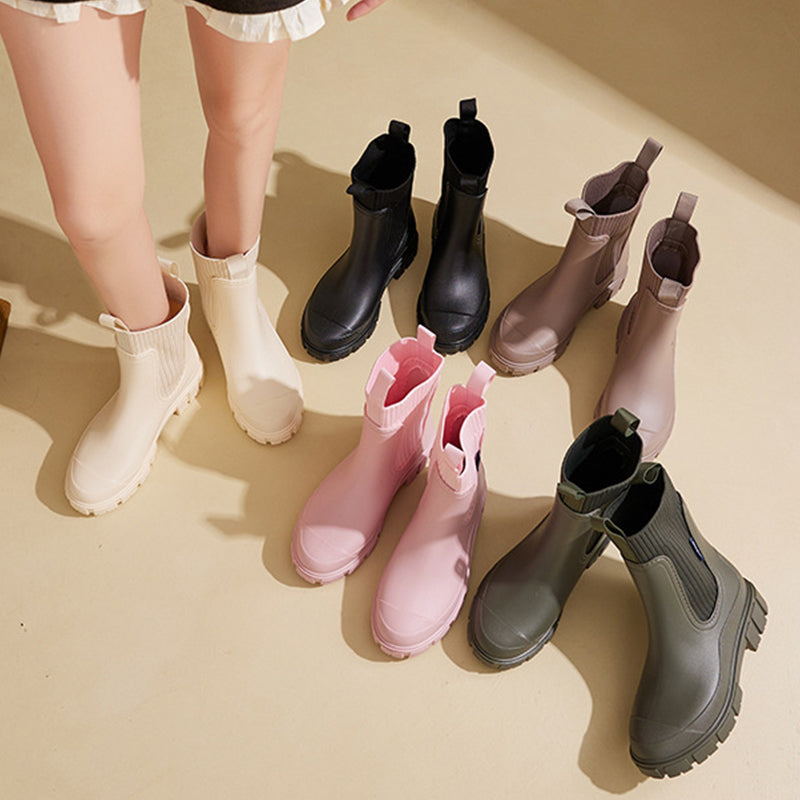 A pair of Arenzza waterproof non-slip thick sole mid-calf boots with sturdy design and textured soles for outdoor wear.