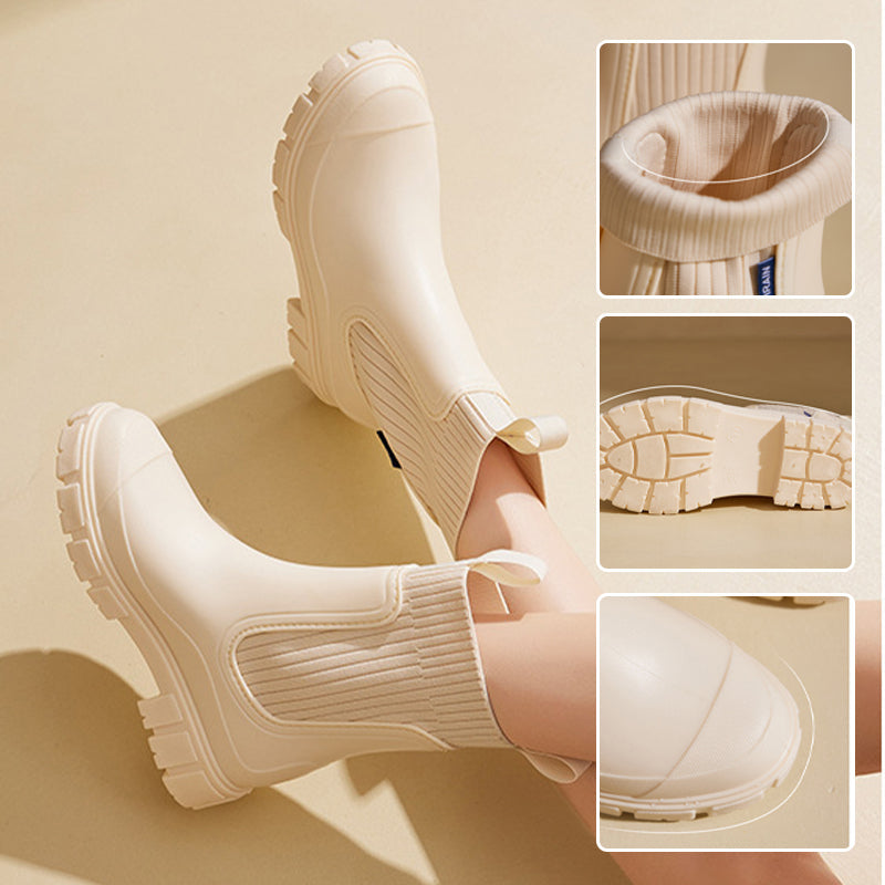 A pair of Arenzza waterproof non-slip thick sole mid-calf boots with sturdy design and textured soles for safety.