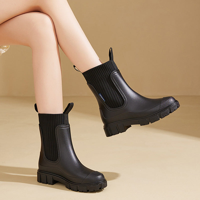 A pair of Arenzza waterproof non-slip thick sole mid-calf boots with sturdy design and textured soles for traction.