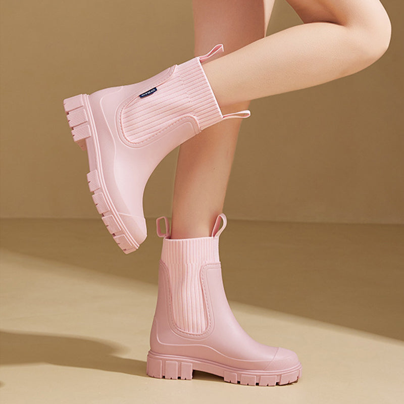 A pair of Arenzza waterproof, non-slip mid-calf boots with thick soles, ideal for wet weather and outdoor activities.