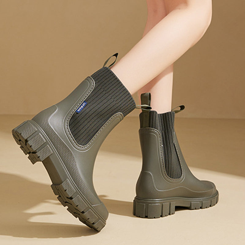 A pair of black Arenzza waterproof non-slip thick sole mid-calf boots with sturdy soles and a sleek, stylish design.
