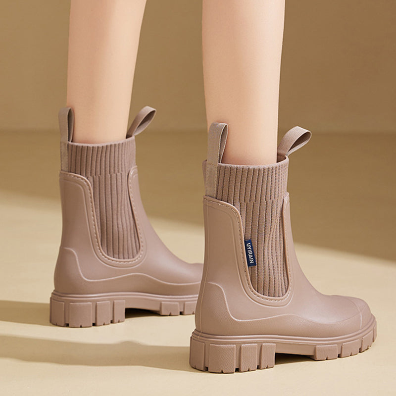 A pair of black Arenzza waterproof, non-slip mid-calf boots with thick soles, suitable for outdoor and rainy conditions.