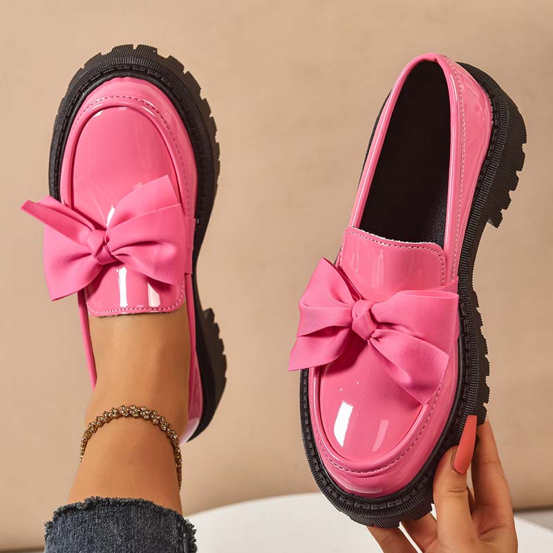 A pair of Arenzza chic purple platform loafers with bows, stylish footwear for women, displayed on a neutral background.