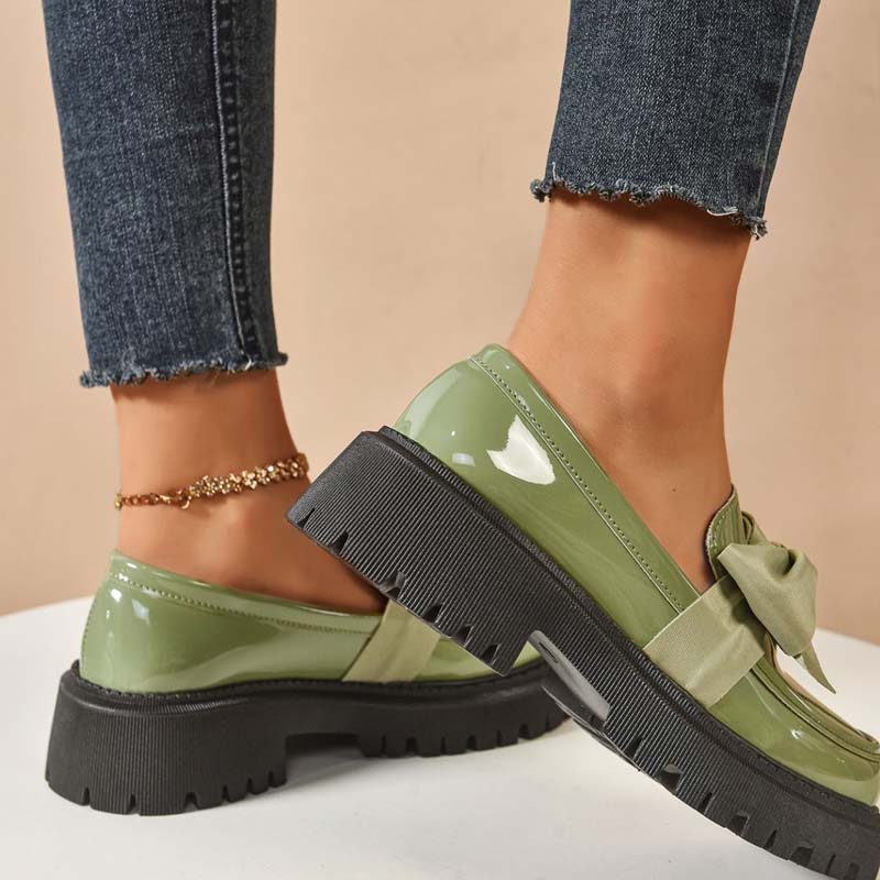 A pair of Arenzza chic sweet platform loafers with bows in purple, featuring a stylish and trendy footwear design.