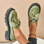 A pair of Arenzza Chic Sweet Platform Loafers with a bow in purple, featuring a stylish and comfortable slip-on design.