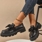 A pair of Arenzza chic sweet platform loafers with bows in purple, featuring a stylish design and comfortable slip-on style.