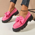 A pair of Arenzza chic sweet platform loafers with bows, featuring a stylish design and comfortable slip-on style.