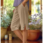 A pair of women's casual solid color pocket Capri pants by Arenzza, displayed on a hanger, showcasing their relaxed fit and simple design.