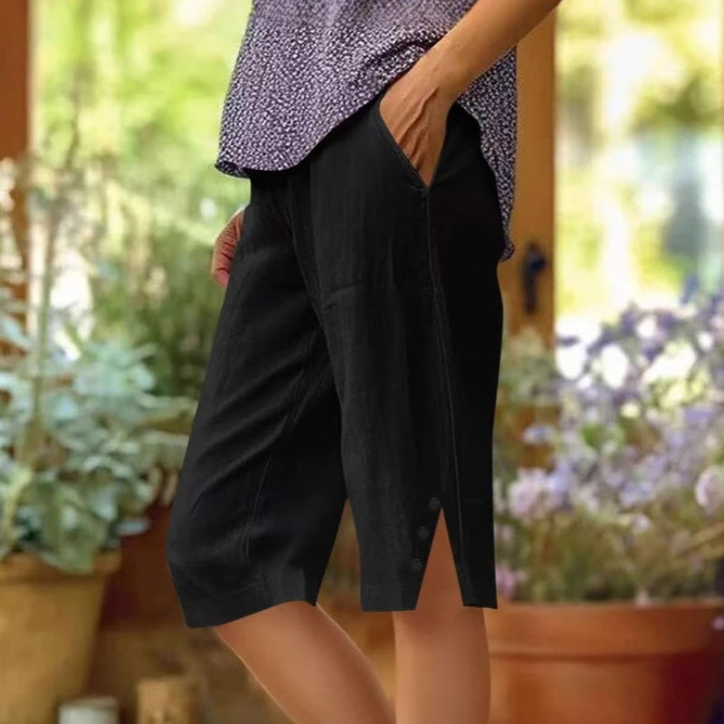 A pair of women's casual solid color pocket Capri pants from Arenzza, featuring a relaxed fit and comfortable fabric.